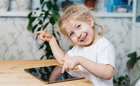 vaikas naudojasi planšetiniu kompiuteriu kūrybiniame žaidime